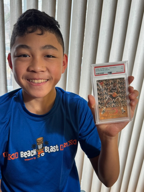 Maddox Holding up the Shaq TV card I purchased years later